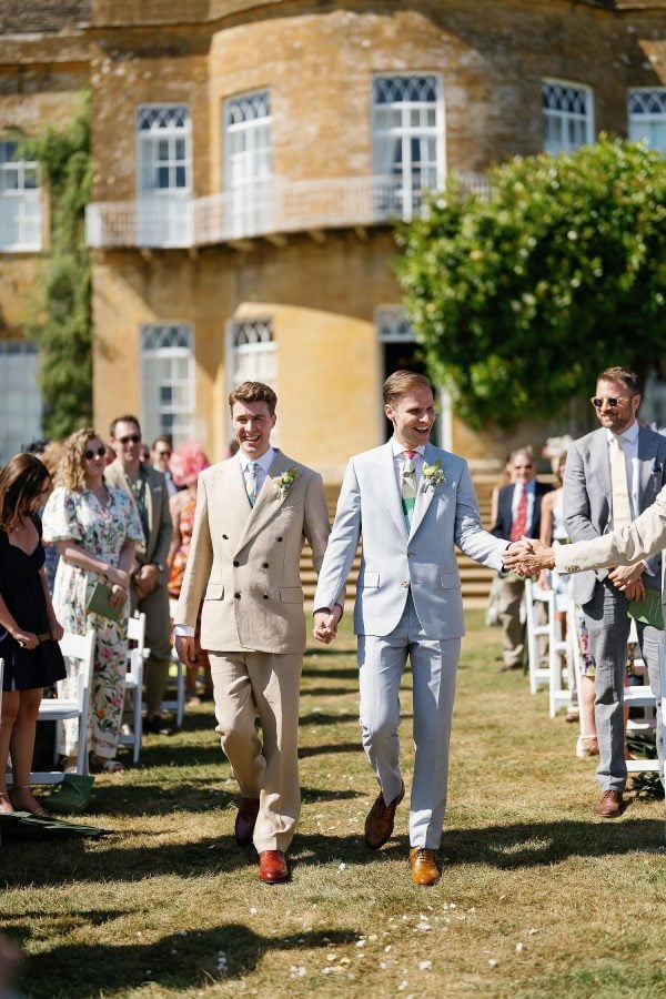 grooms walking down the aisle