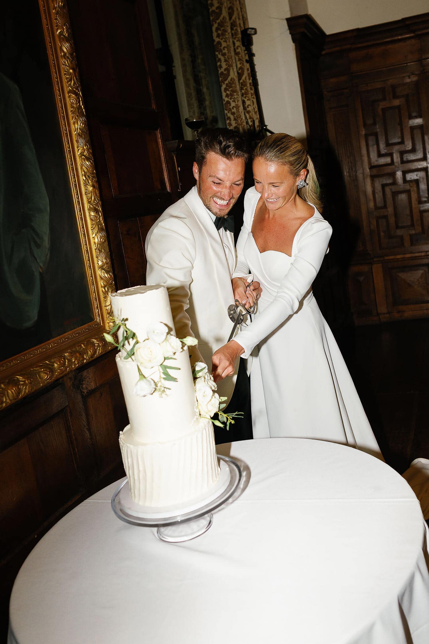 bride and groom cutting cake