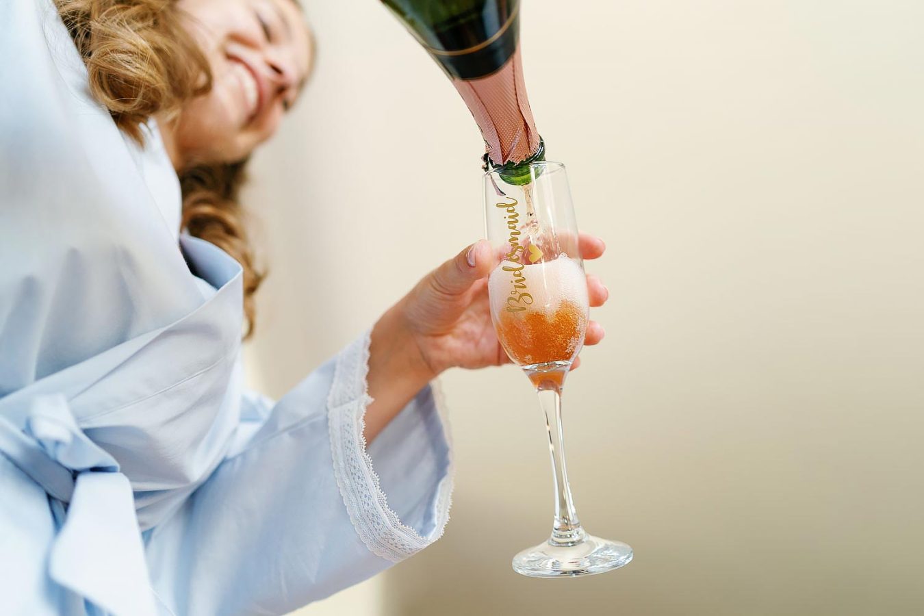 bridesmaid pouring champagne