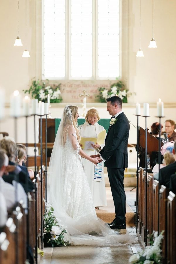 bride and groom saying vows in Lulworth Castle church