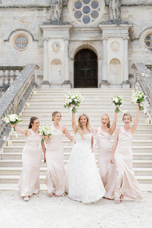bridesmaids on steps of Lulworth Castle