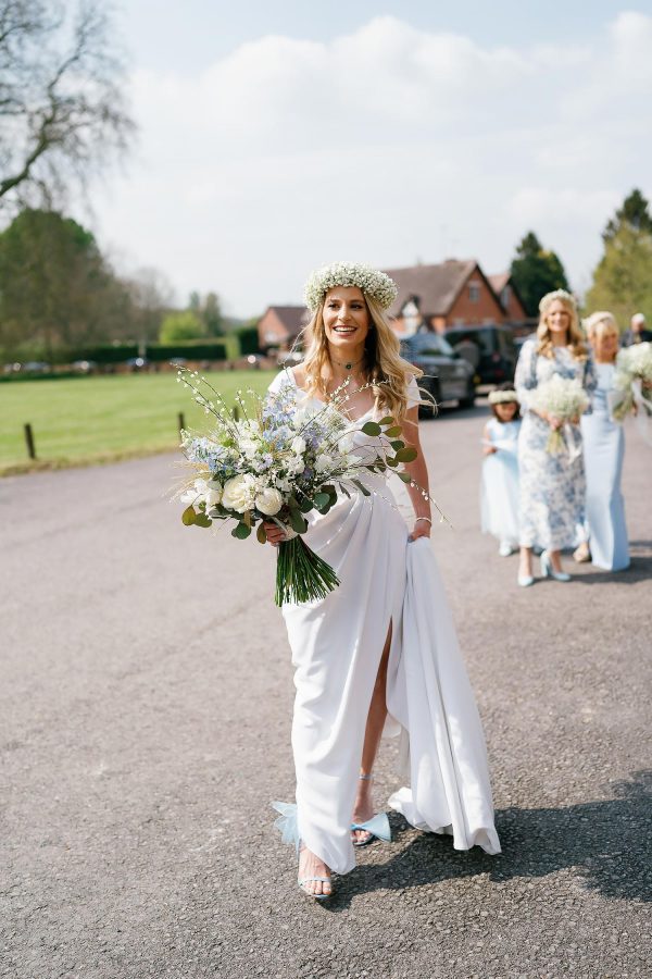 bride in flower crown outside St Giles House church