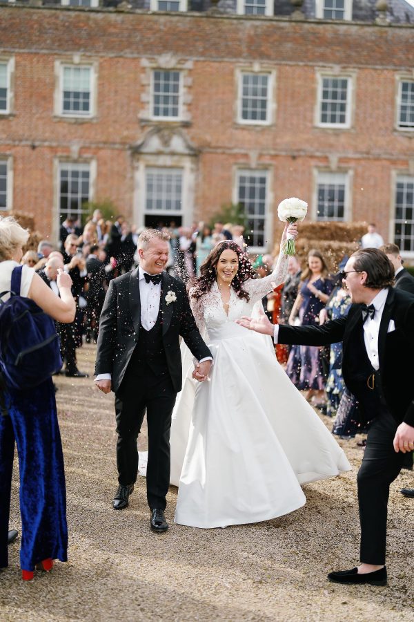 bride and groom confetti outside St Giles House