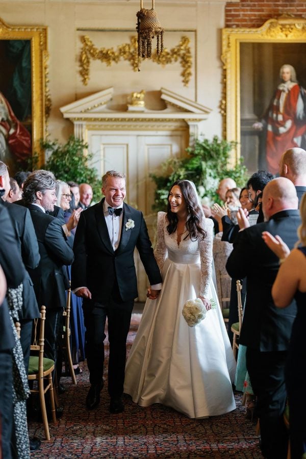 bride and groom walking down aisle together