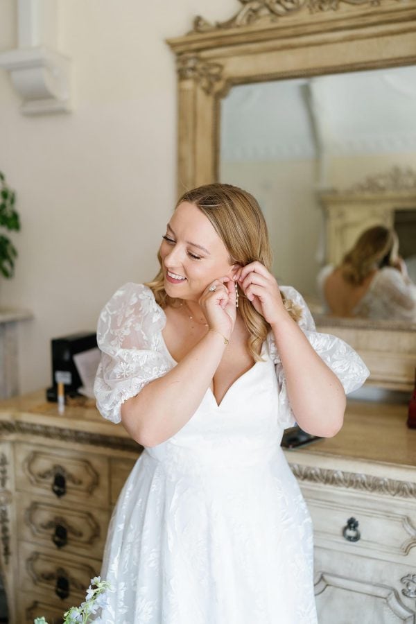 bride putting on her earring