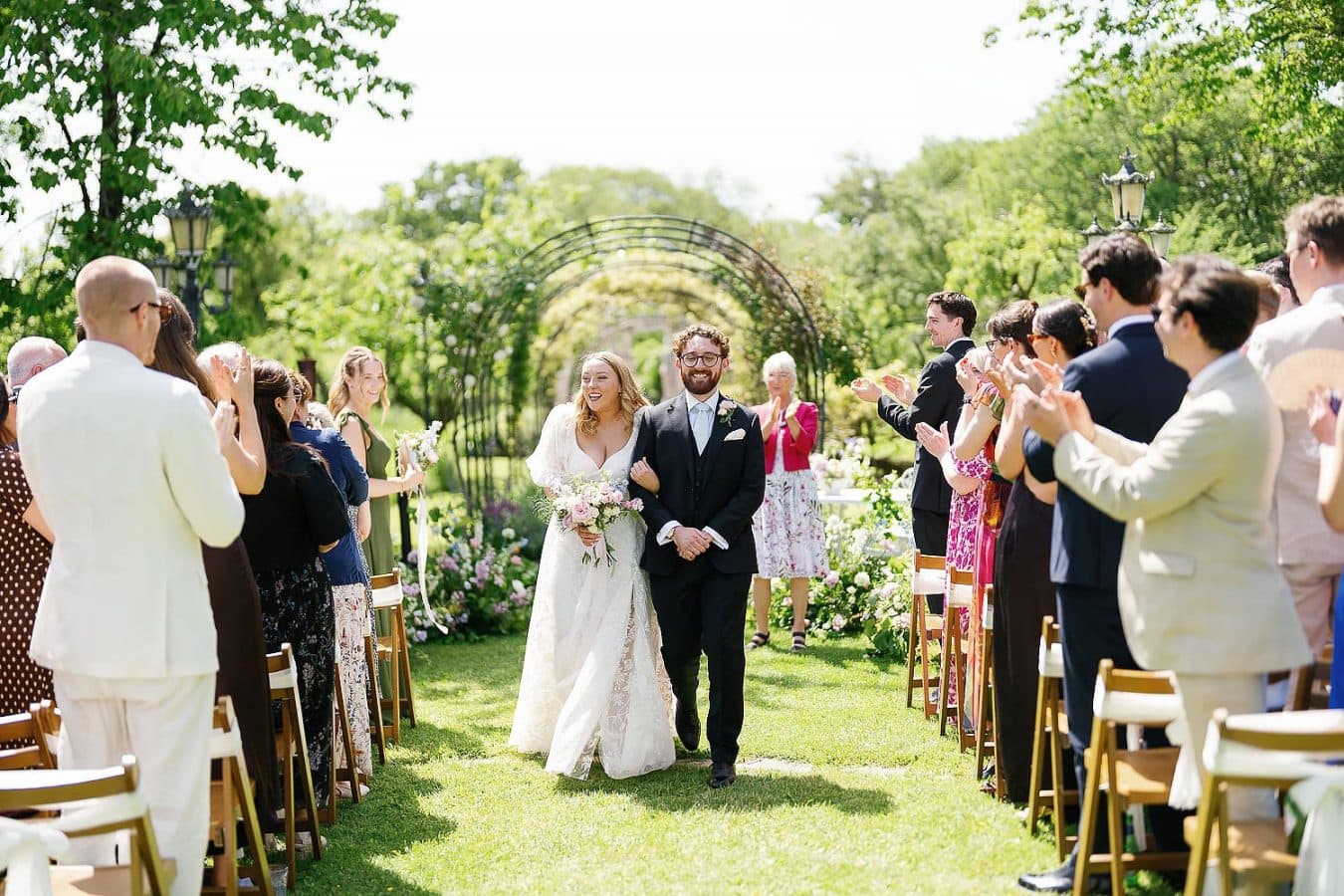 bride and groom walking down the aisle outside Berwick Lodge