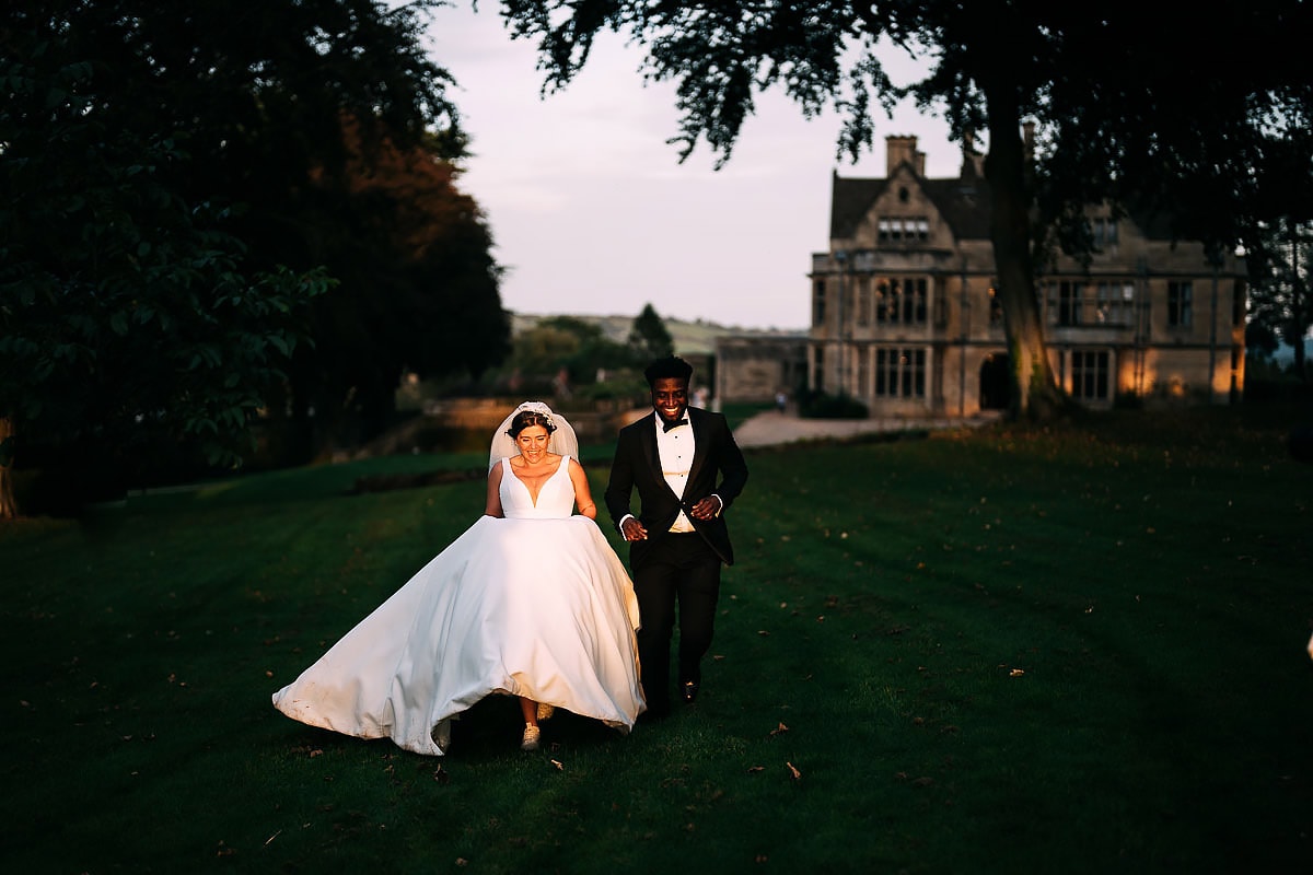 bride and groom running in to sun