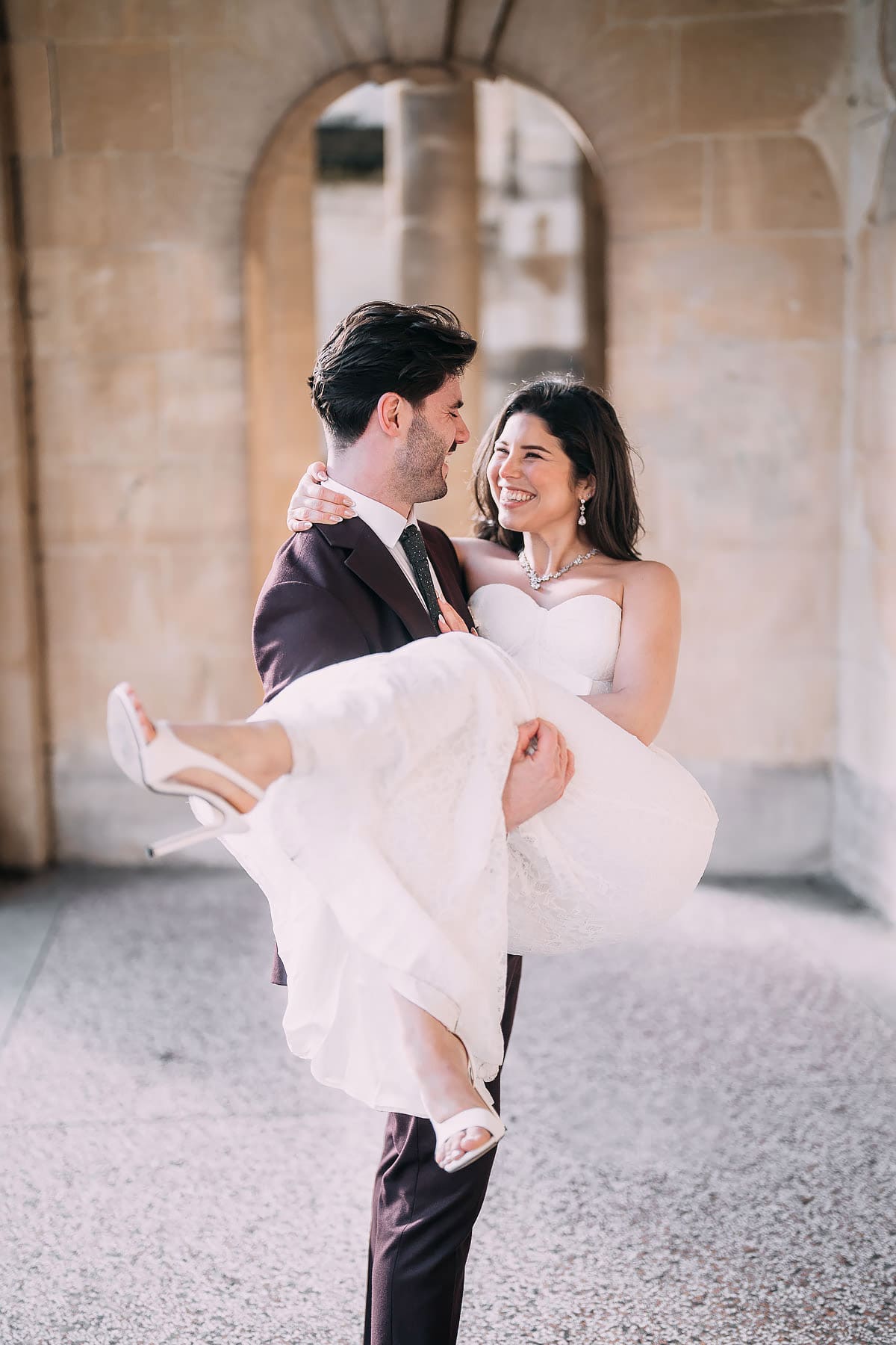 groom carrying bride