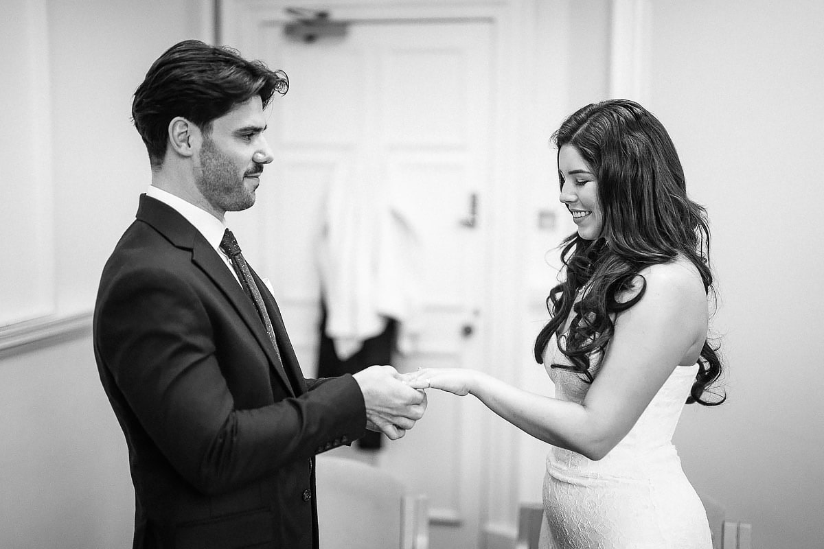 bride and groom exchanging wedding rings in bath registry office