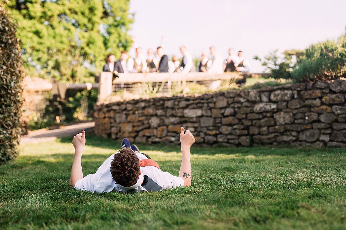 man lying on grass at wedding