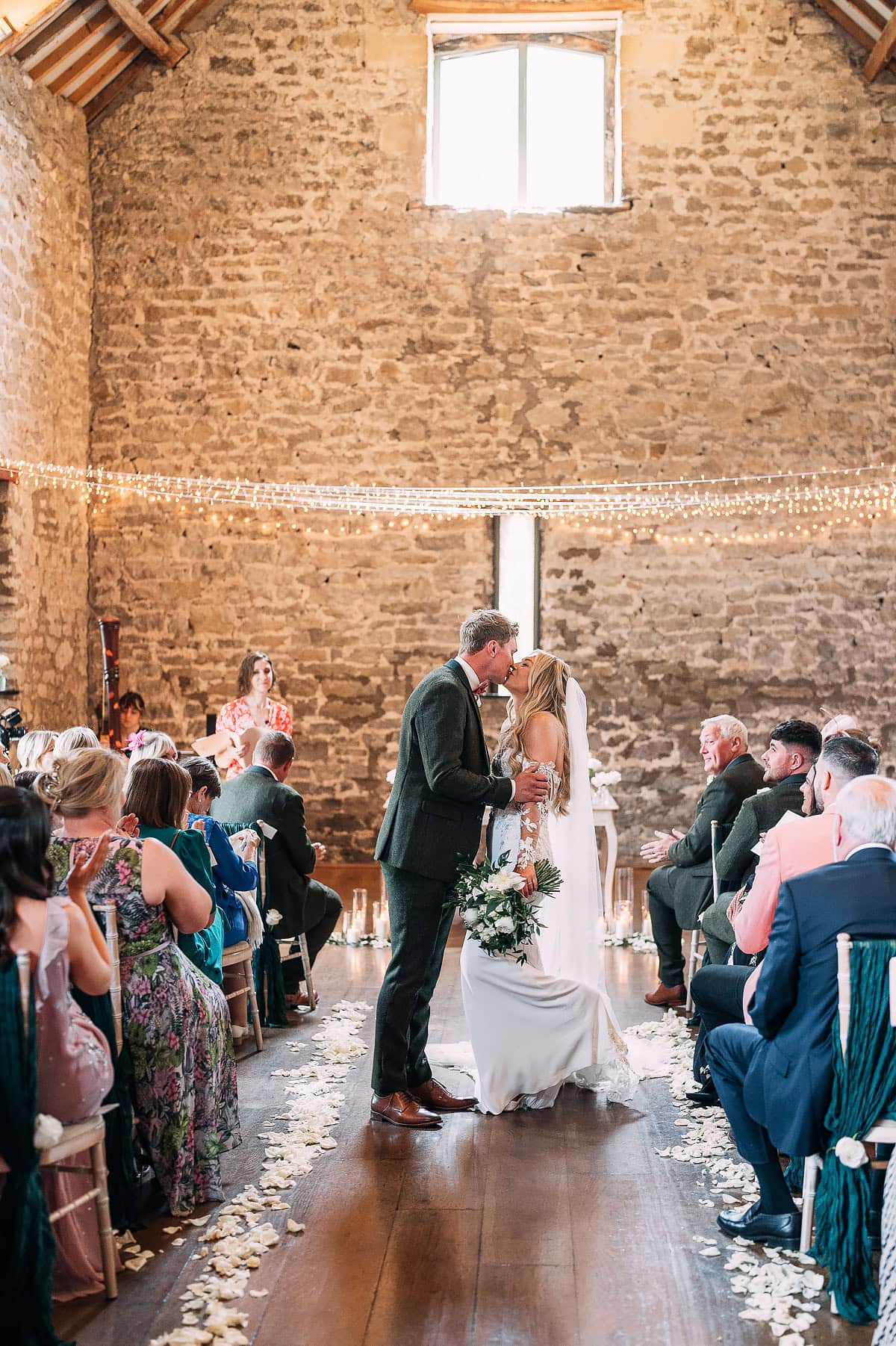 bride and groom kiss at Priston Mill wedding ceremony 