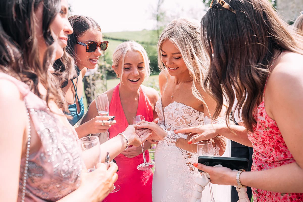 friends looking at wedding ring