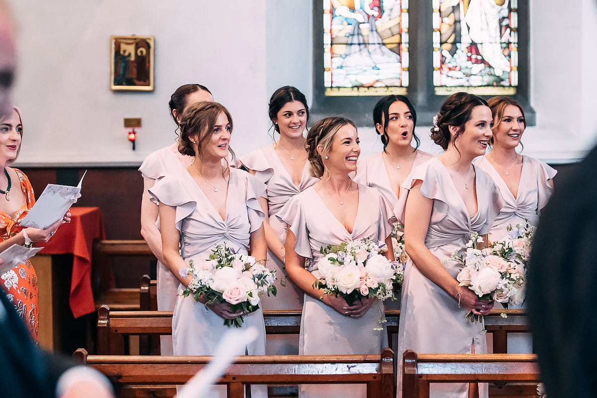 bridesmaids smiling in church wedding