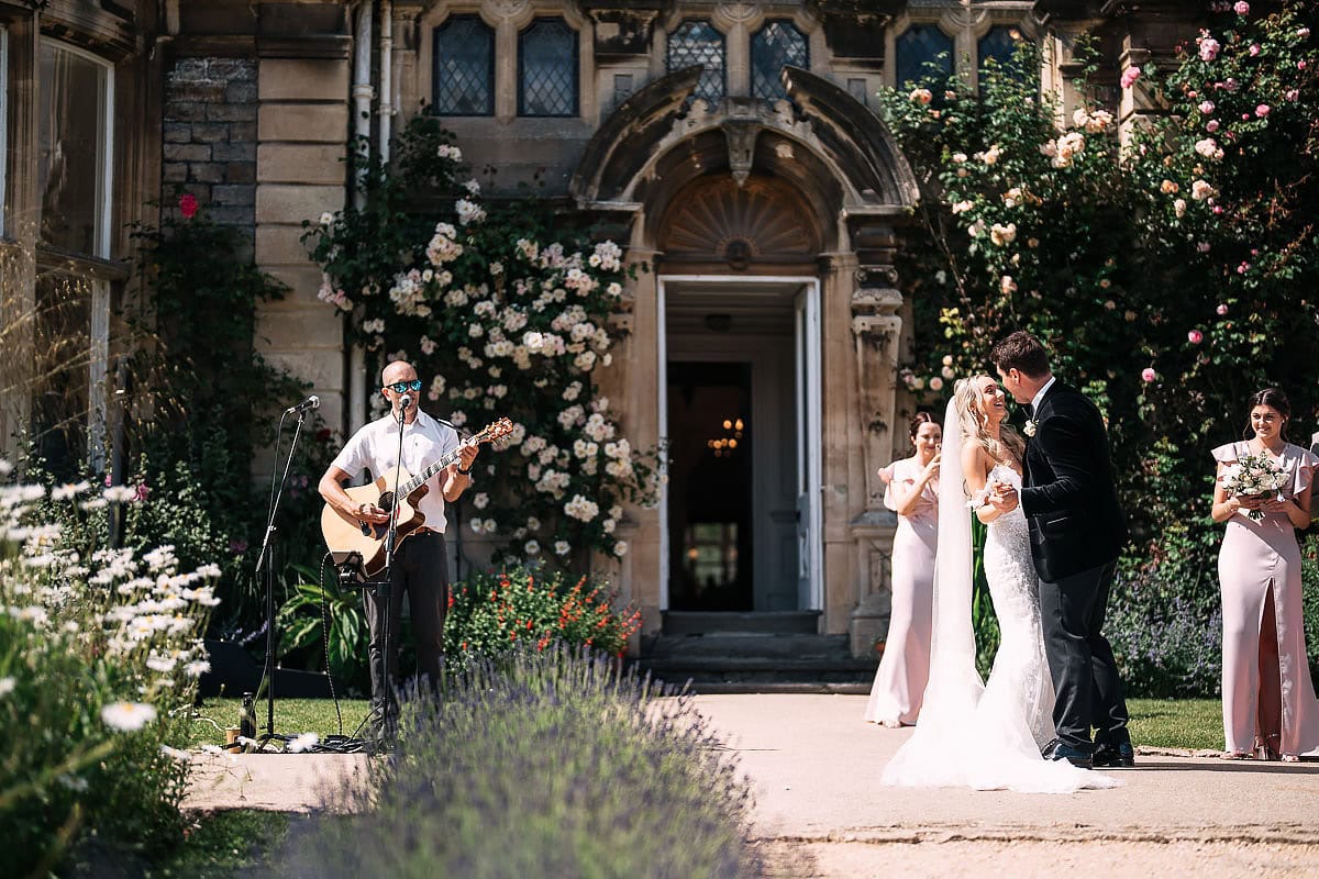 bride and groom dancing together outside Clevedon Hall wedding