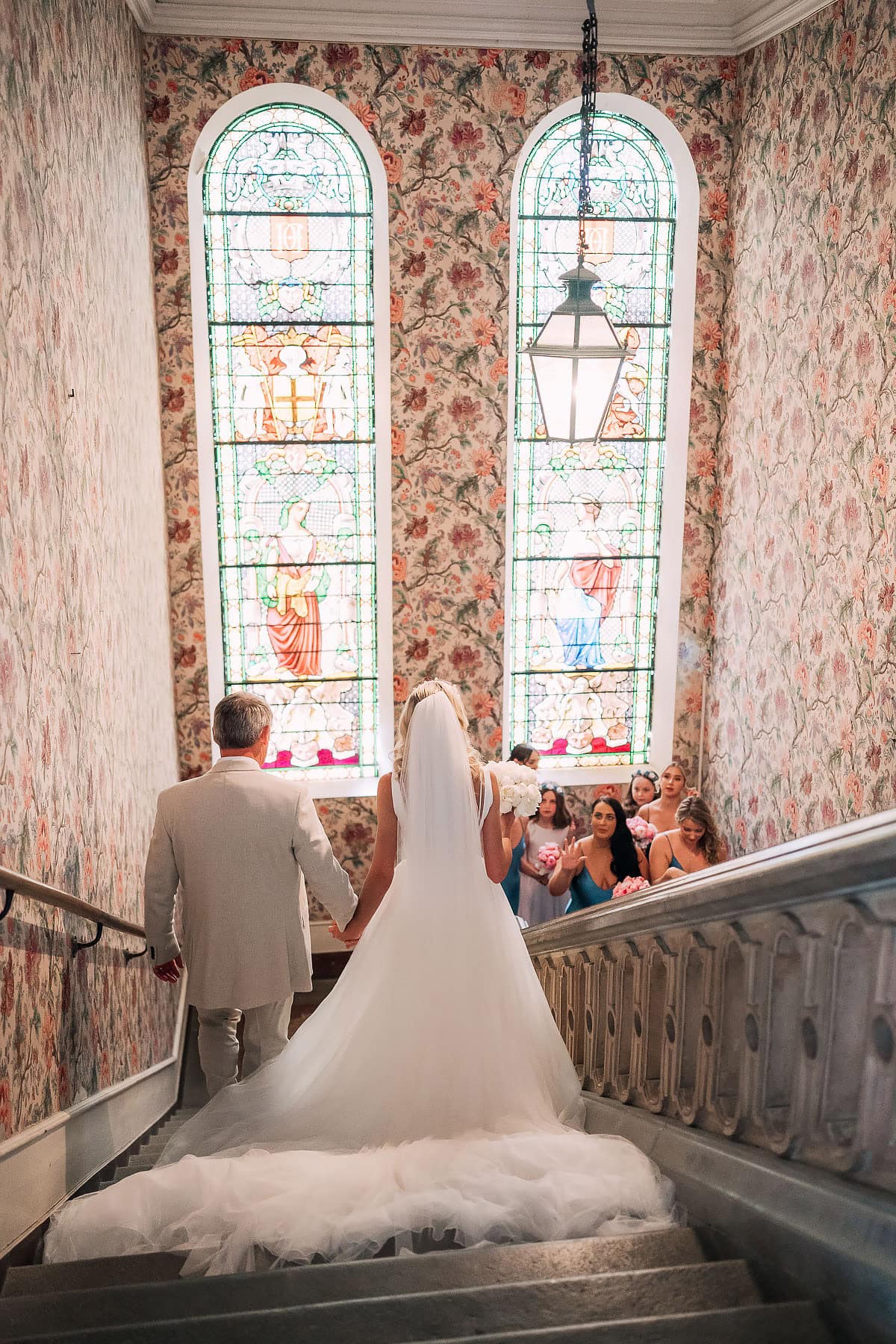bride walking down stairs inside Chateau De Seyre