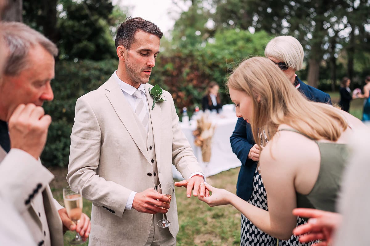 groom showing off his wedding ring