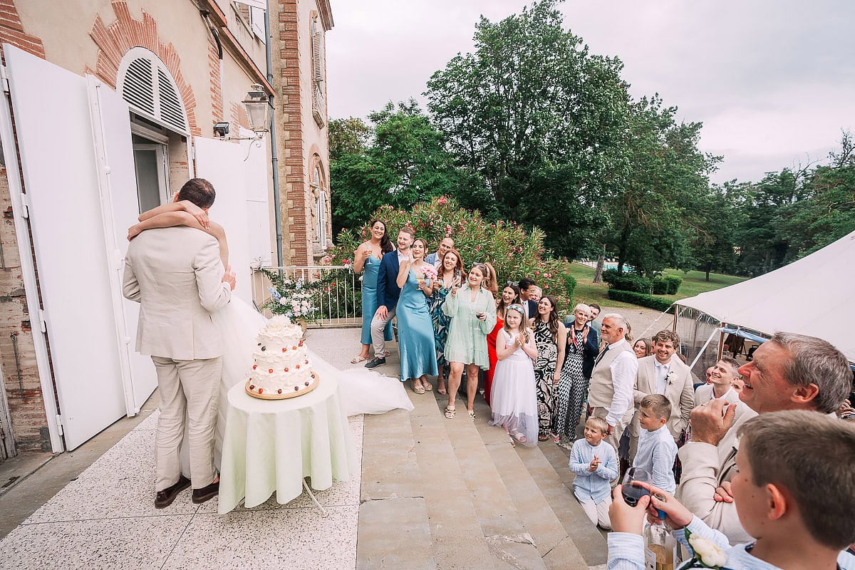 cutting the cake on the stairs of Chateau De Seyre