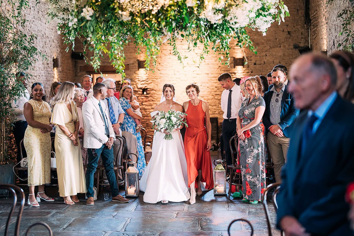 bride and mum walking down the aisle