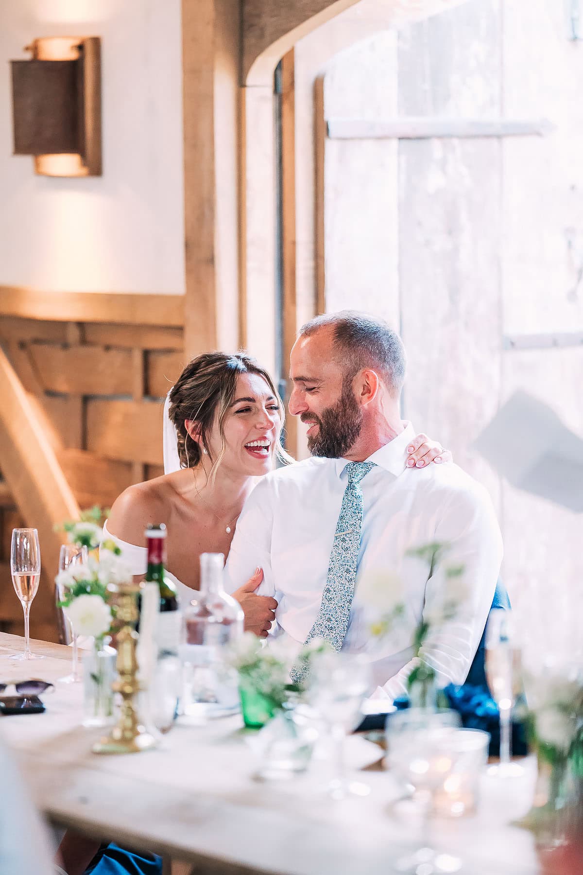 bride and groom laughing to-gether
