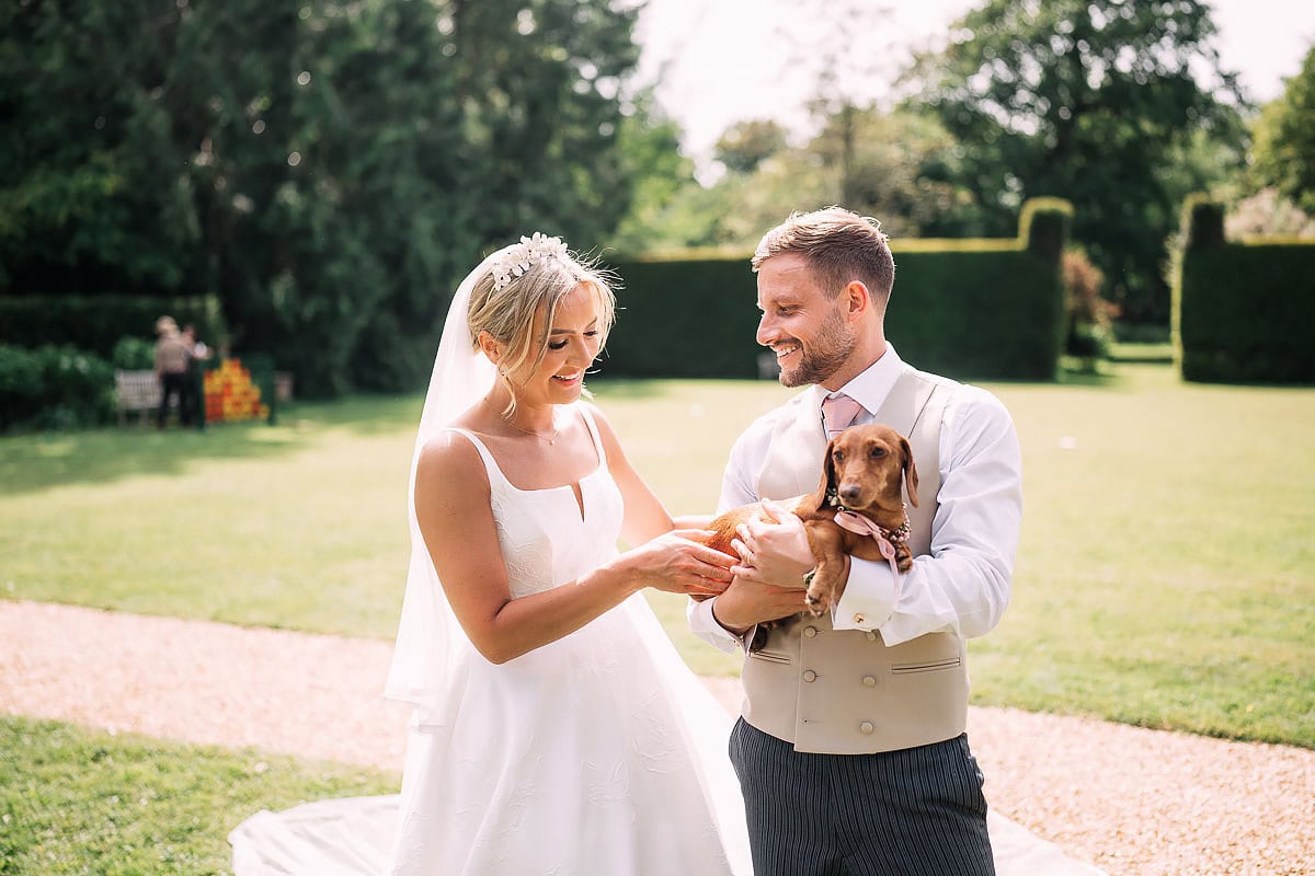 bride and groom and their sausage dog