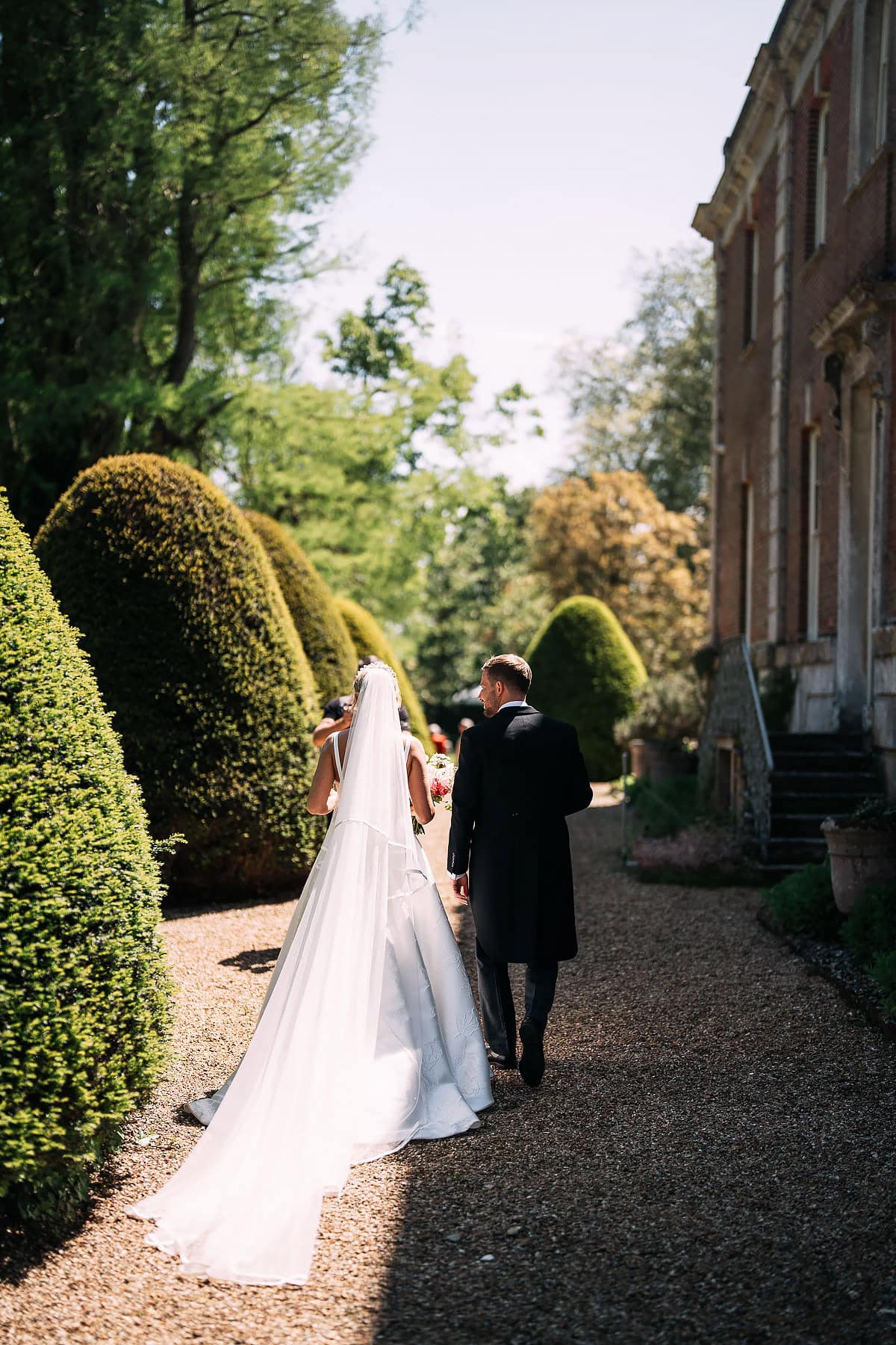 bride and groom walking in Deans Court