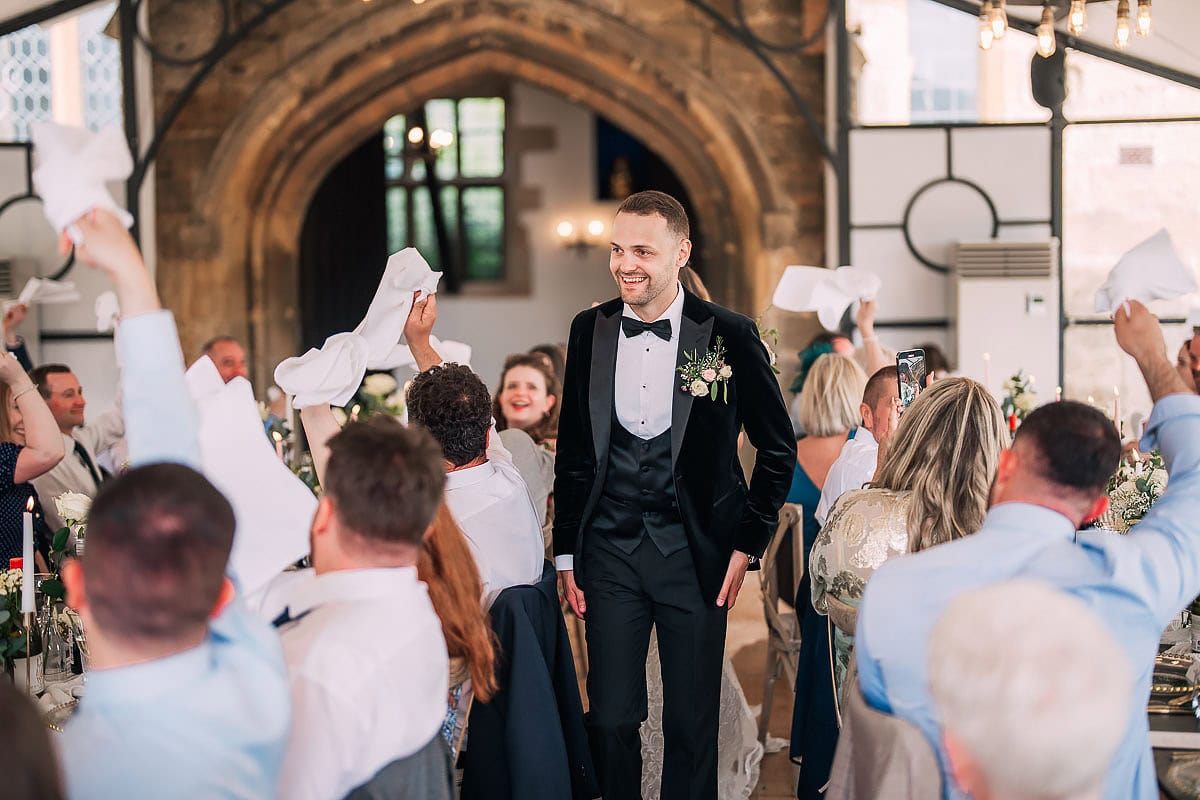groom walks in to wedding reception