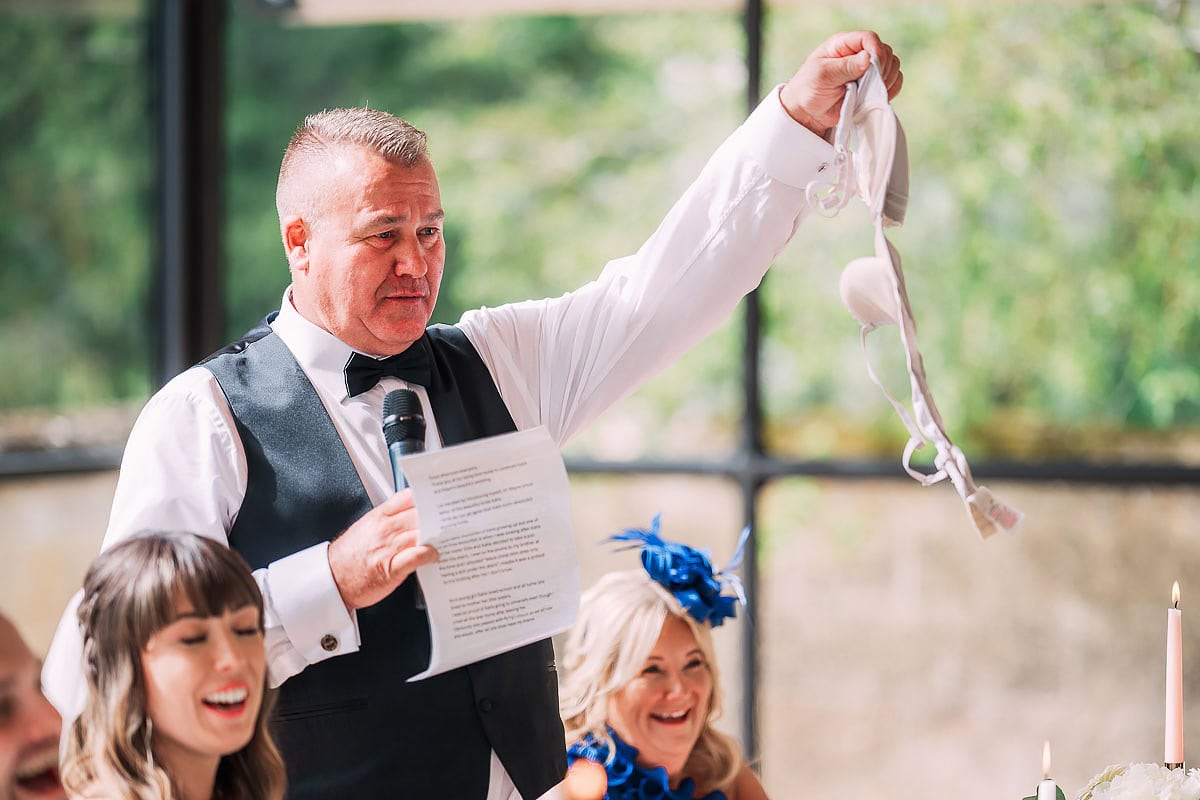 father of the bride holds up bra