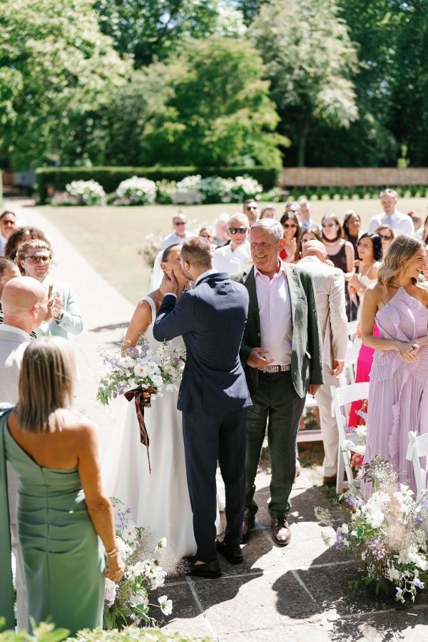 bride and groom kissing outdoor ceremony