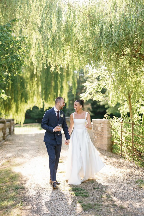 bride and groom by bridge in deans court