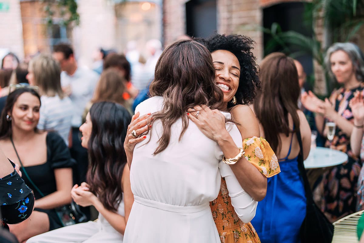friend hugging bride