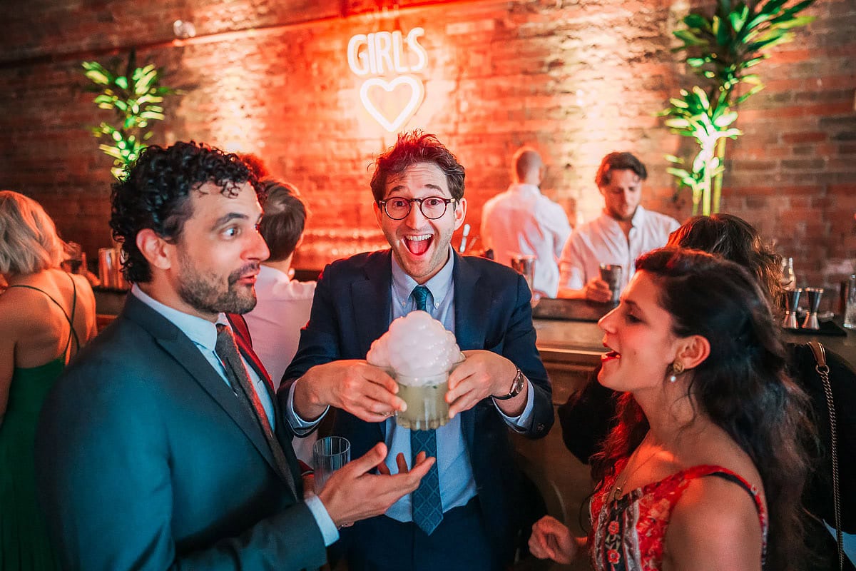 wedding guests getting cocktails with bubbles on 