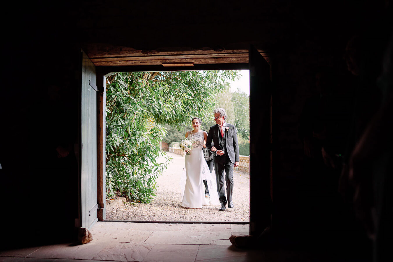 bride and father walkign down aisle