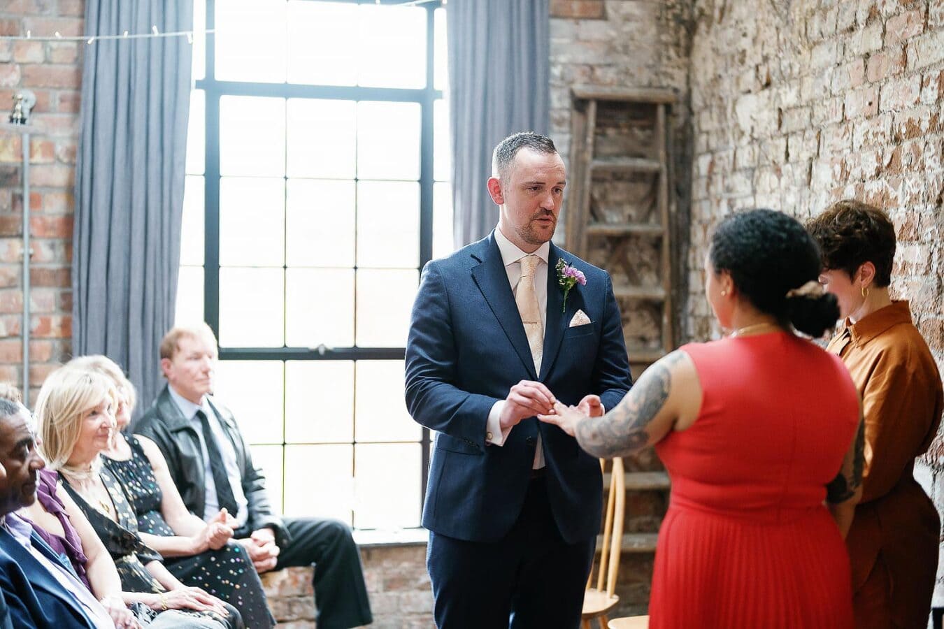 bride and groom exchanging rings