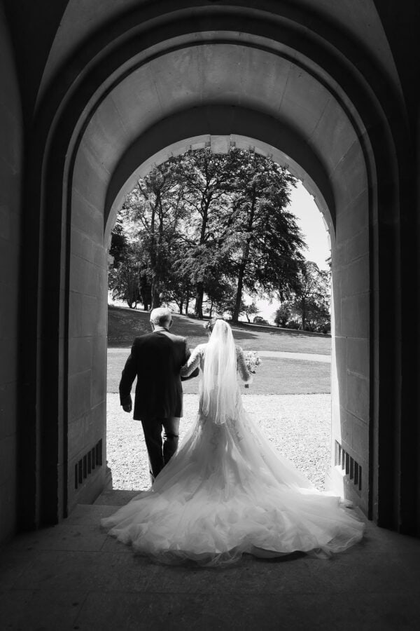 bride and her father walking out of the door