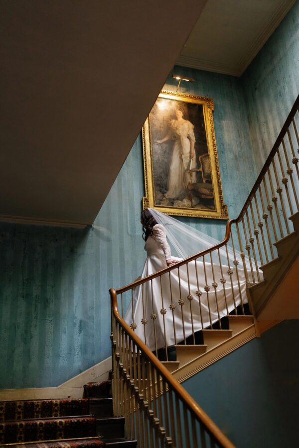 bride walking down stairs in st giles house