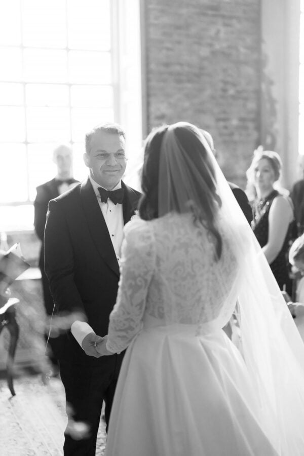 groom looking at bride during wedding ceremony
