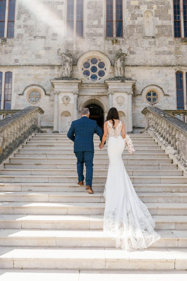 bride walking up lulworth castle steps