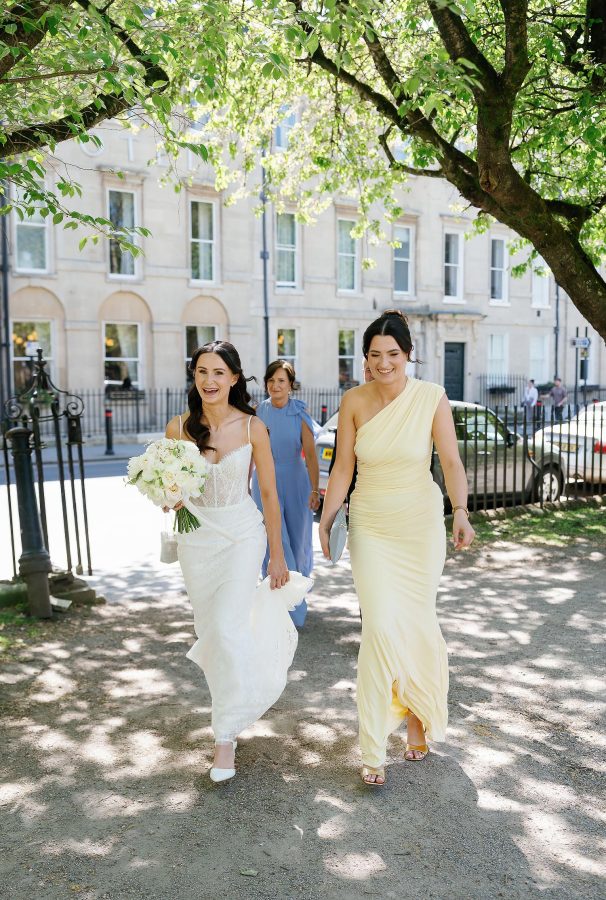 bride walking through queen square park in bath