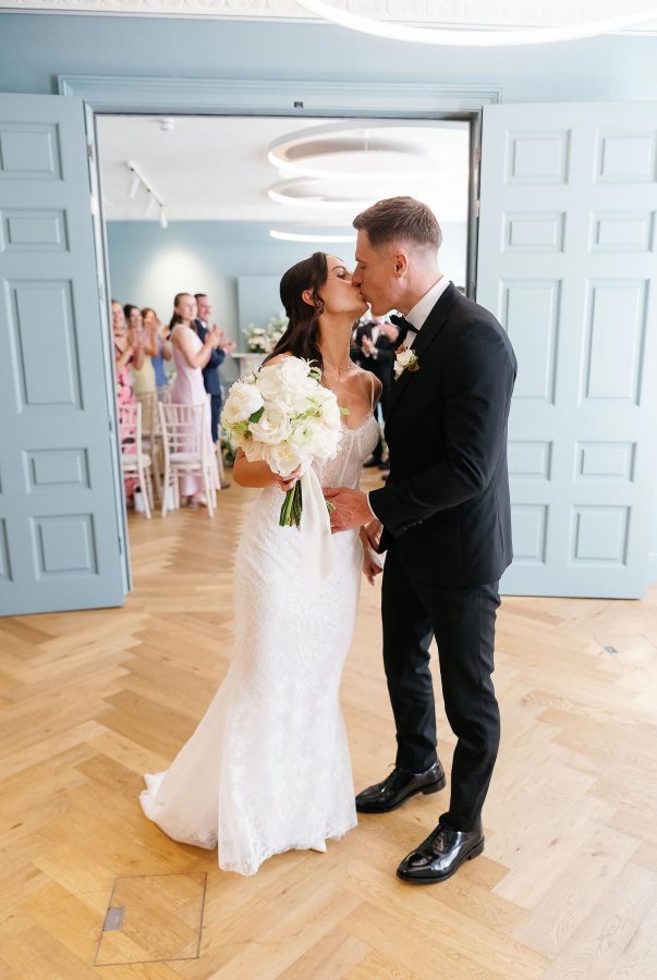 bride and groom kiss after wedding ceremony