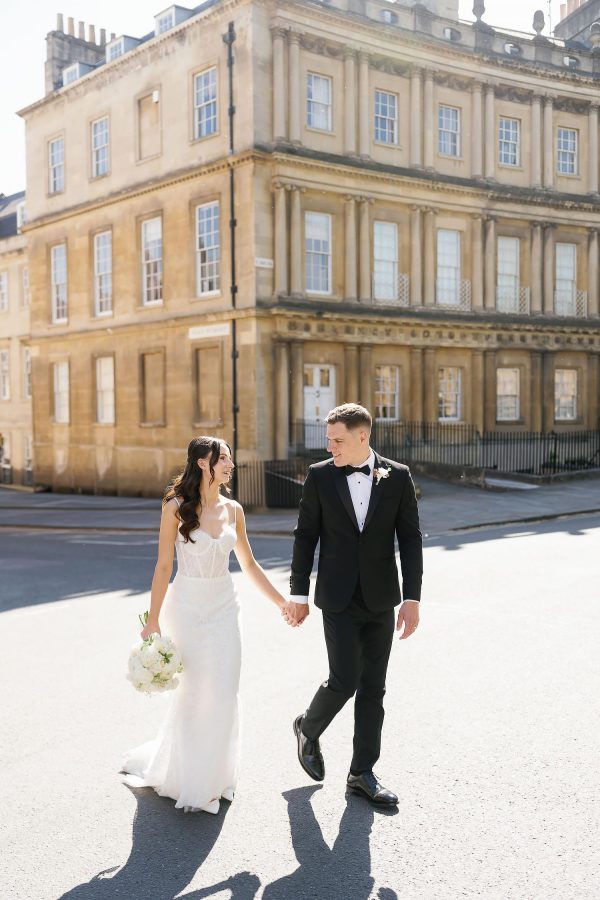 bride and groom walking through bath