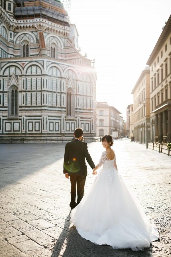 couple walking by a church