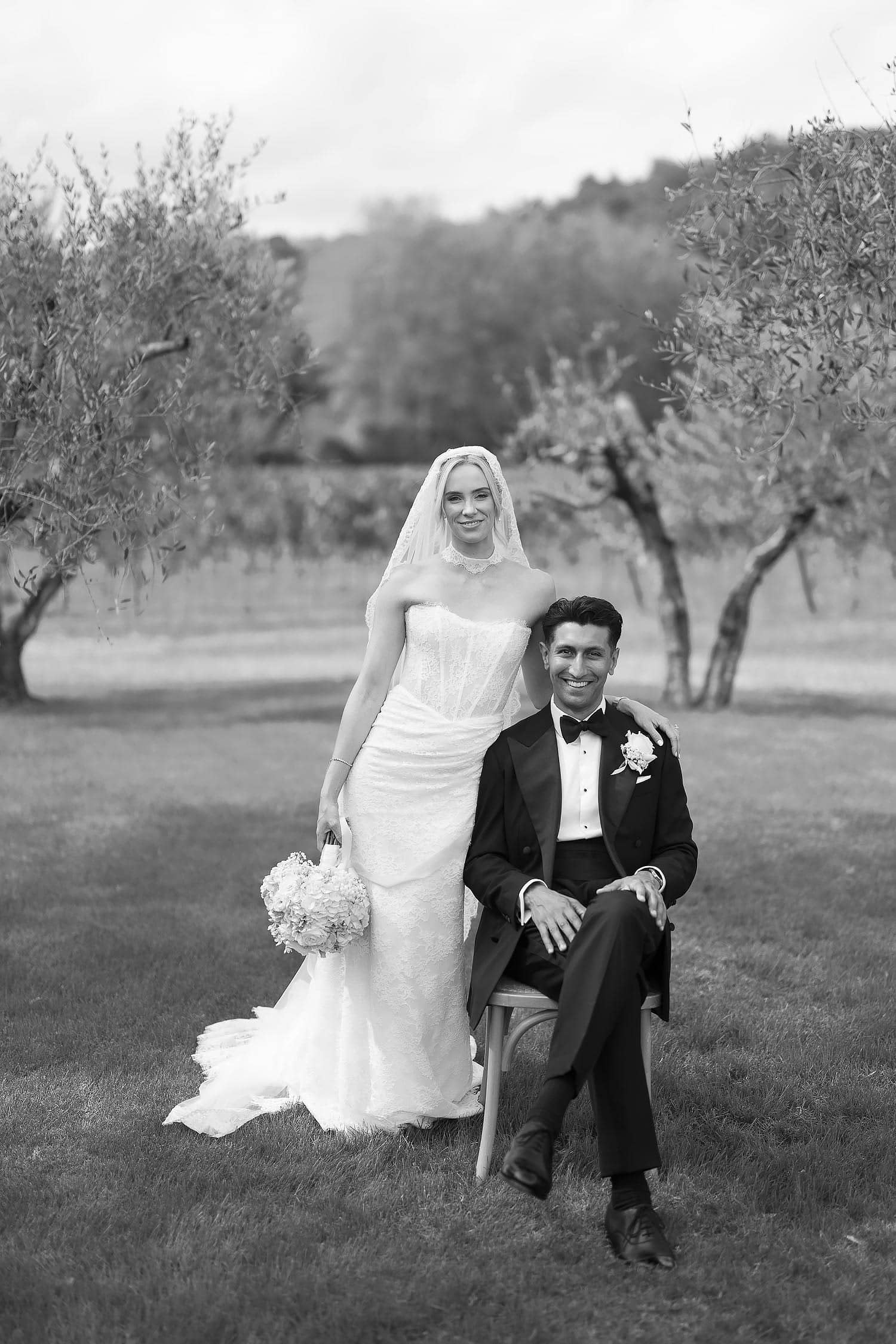 groom sat on chair wedding portrait